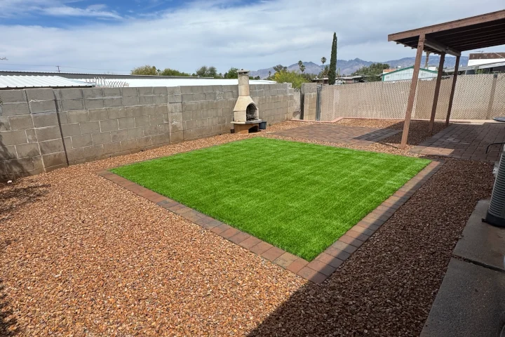 Square artificial grass section in backyard patio — synthetic turf by Luis Landscapes Tucson