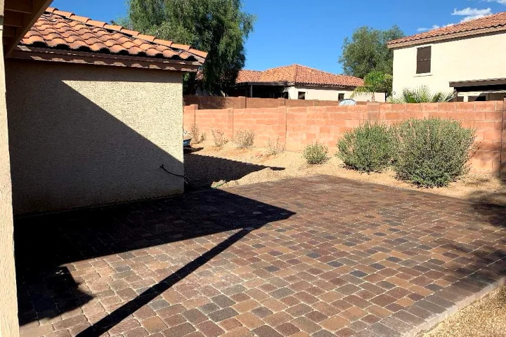 Brick paving patio with decorative gravel borders installed by Luis Landscapes in Tucson