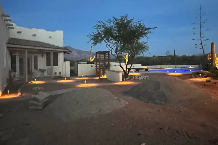Landscape lighting installation in progress at Tucson residential yard by Luis Landscapes
