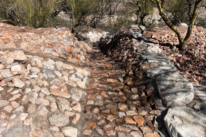 Decorative rock water chute feature installed by Luis Landscapes in Tucson