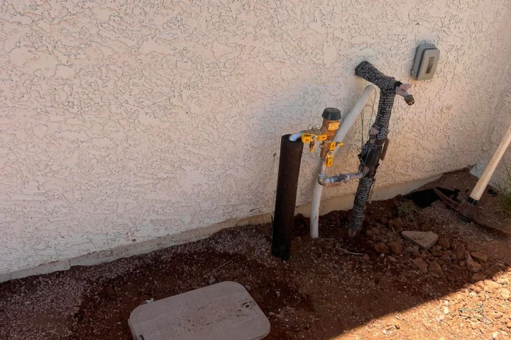 Irrigation pipe diagnostic and inspection against house exterior by Luis Landscapes Tucson