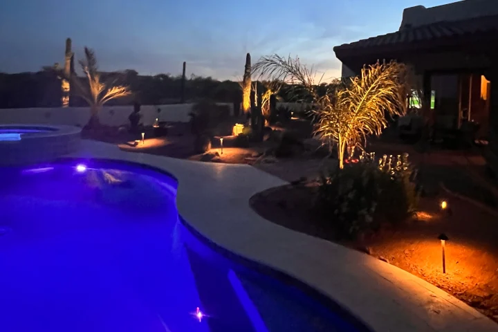 Outdoor decorative lights illuminating pool patio area — landscape lighting by Luis Landscapes