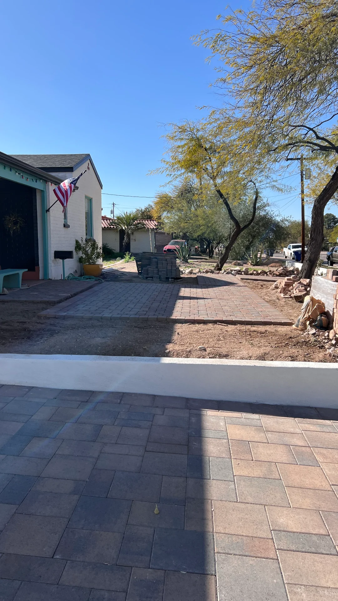 Front-yard pavers installation showing interlocking pavers across a driveway and walkway.